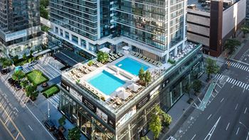 an aerial view of a building with a pool on top of it at SKY Apartments, New York